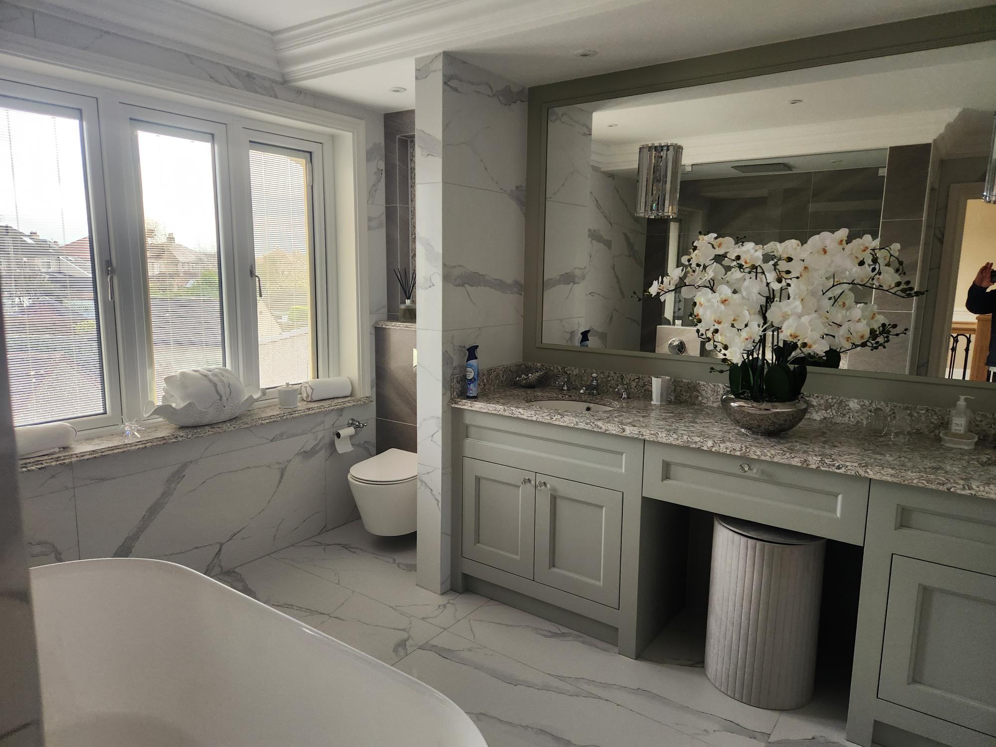 Luxury marble bathroom with fitted vanity unit and granite worktop