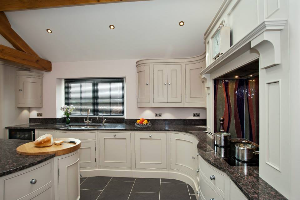 Bespoke curved kitchen with granite worktops and glass splashback