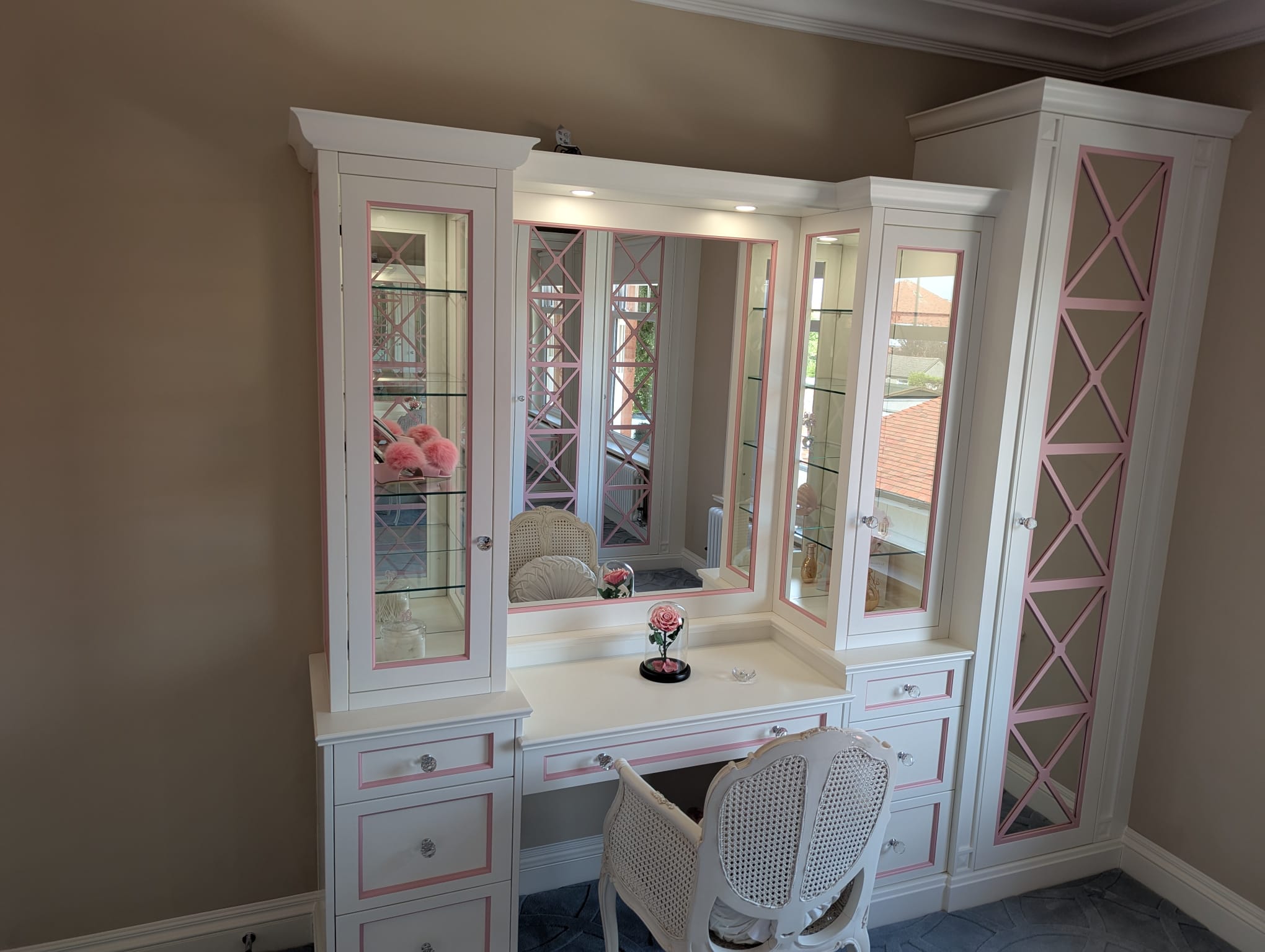 Bespoke white and pink dressing room with glass display cabinets