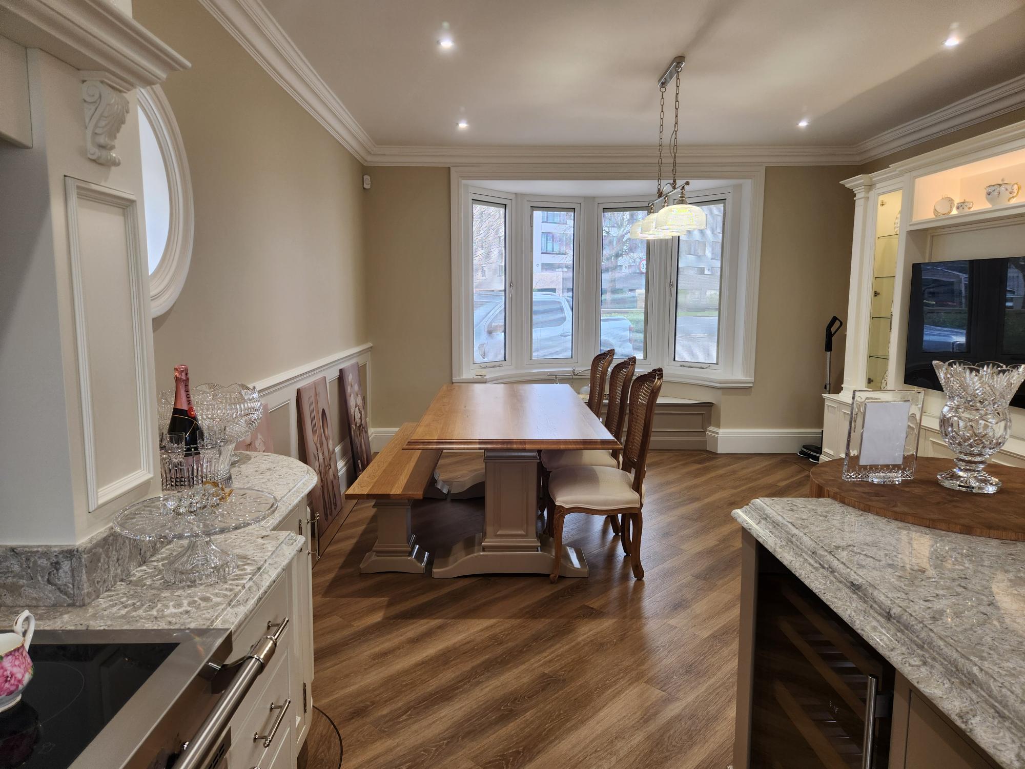 Kitchen dining area with bespoke oak table and bay window