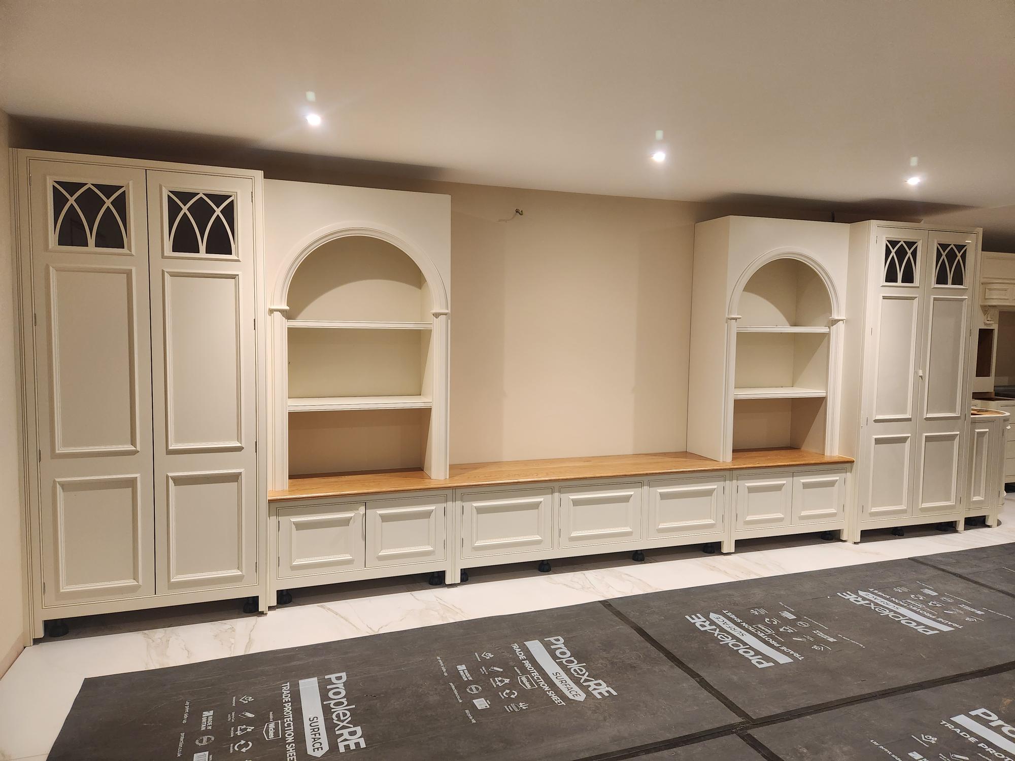 Bespoke cream dresser unit with arched alcove shelving and gothic glass details
