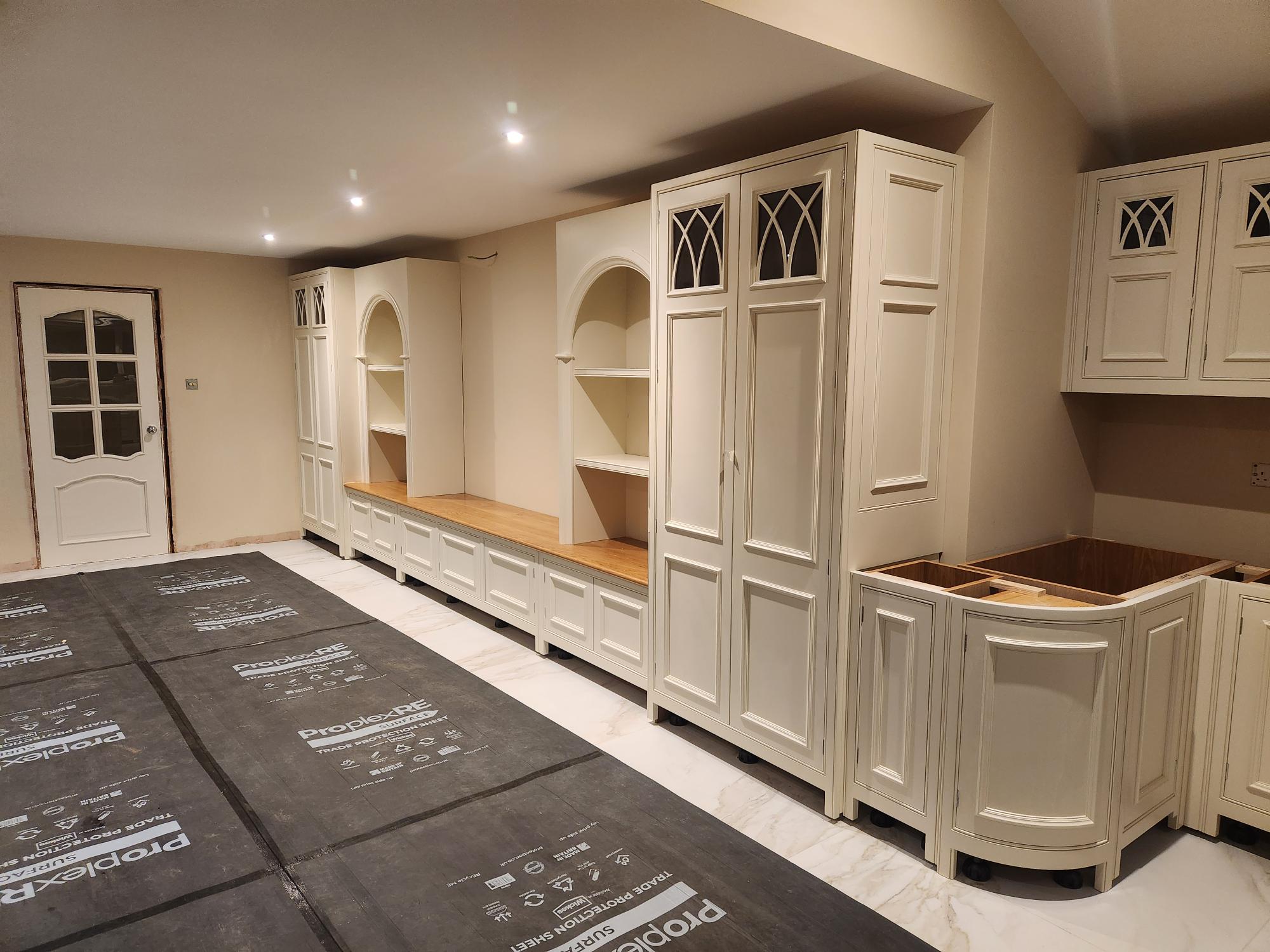 Full view of luxury traditional kitchen with arched alcoves and curved units