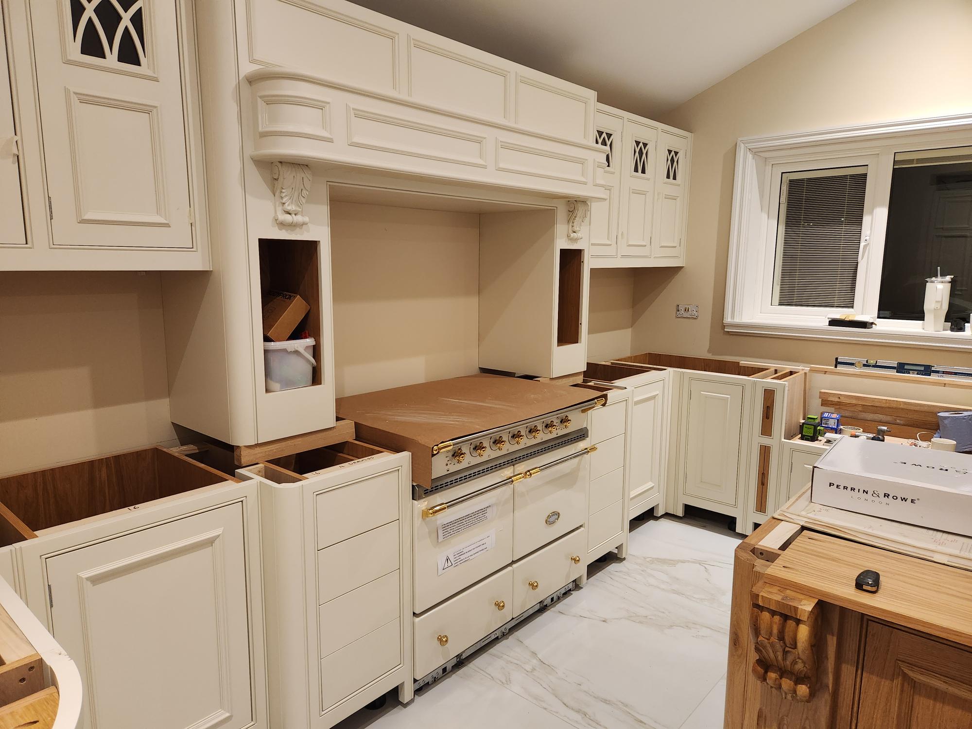 Hand-painted kitchen with ornate range cooker surround and carved corbels