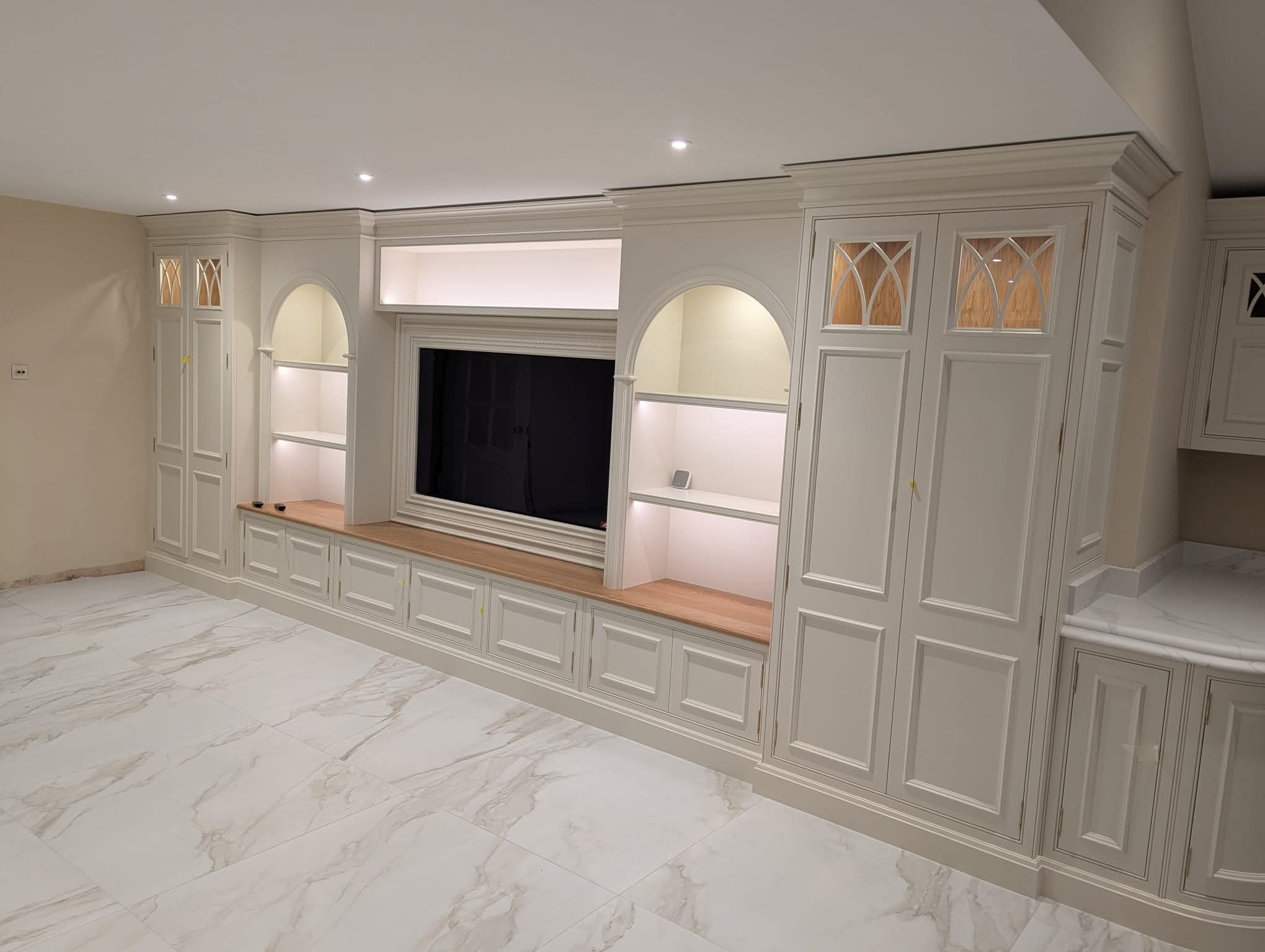 Full-length fitted entertainment unit with integrated lighting