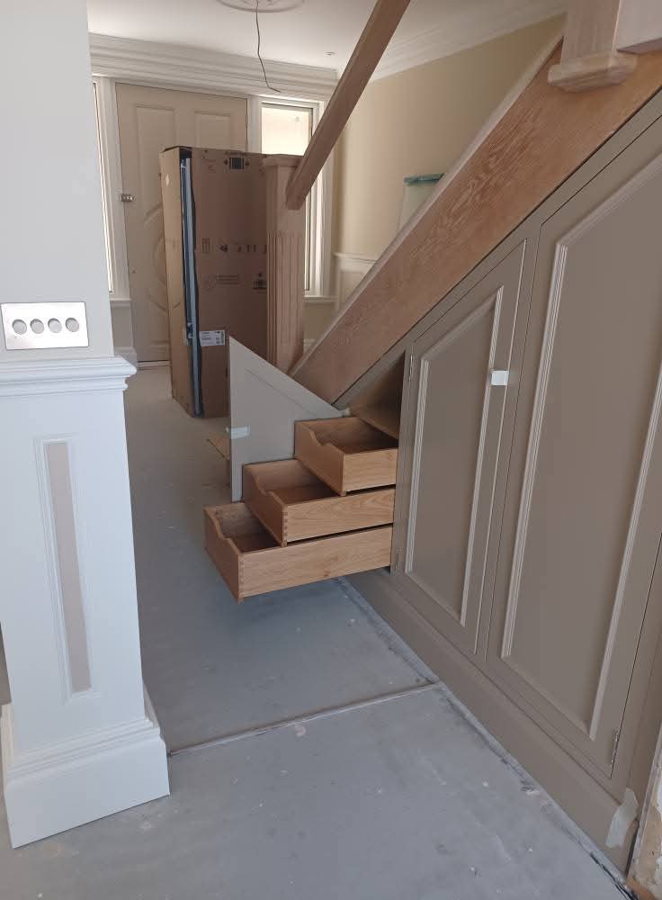 Bespoke stair tread drawers with oak interiors and painted finish
